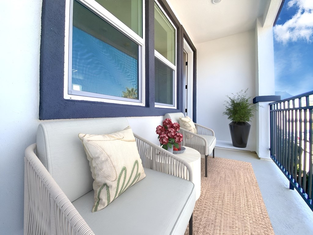 a balcony with two chairs and a table and a window at The Willow Townhomes, California