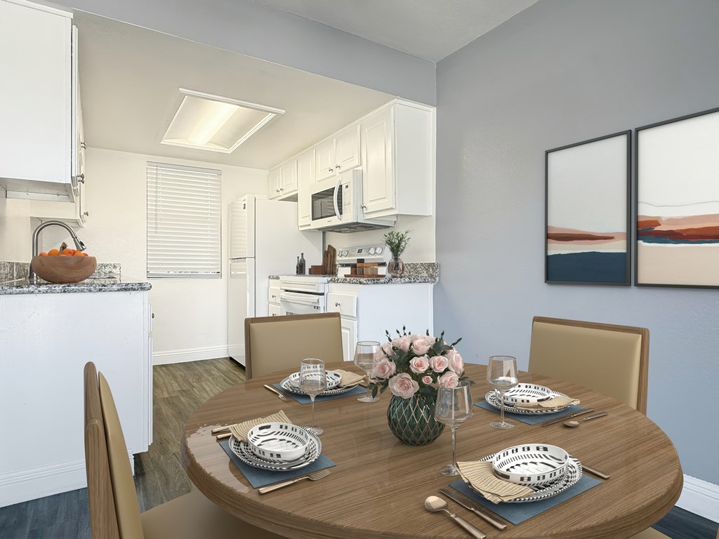 A modern kitchen with a dining table set for two at Broadview Apartments, San Bernardino California