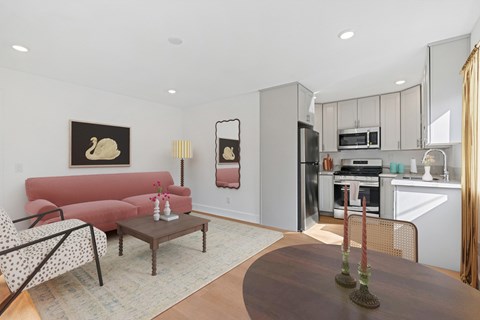 A living room with a red couch and a coffee table.