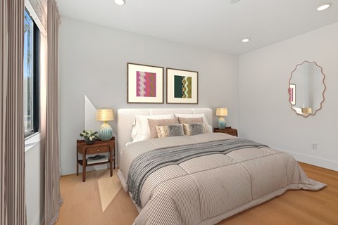 Spacious bedroom in Mar Vista apartment with plank flooring and large windows allowing for gorgeous natural lighting