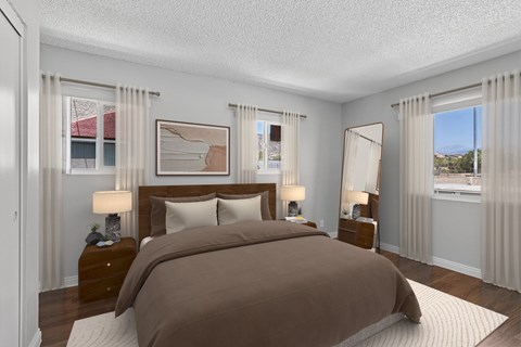 Spacious bedroom in 1 bed 1 bath Azusa Gardens apartment home with wood style plank flooring, multiple windows for natural lighting and views, and a private bathroom