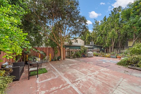 Exterior courtyard at 6128 Wilshire surrounded by trees and lush greenery