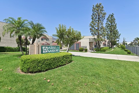 A green sign that says "AZURE GARDEN" is in front of a building.
