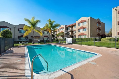 A swimming pool in front of a residential building.
