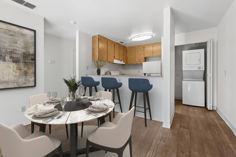 A modern kitchen with a dining table set for four.