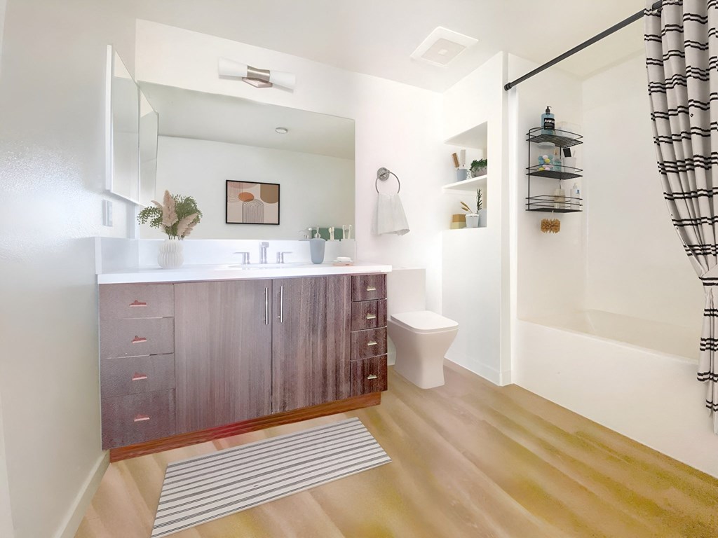 a bathroom with a sink and a toilet and a shower at The Max on Jefferson Apartments, Murrieta, CA