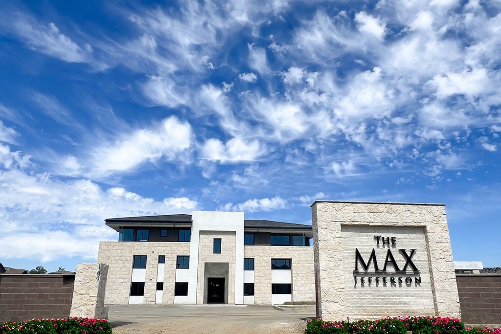 the building with a blue sky background at The Max on Jefferson Apartments, California