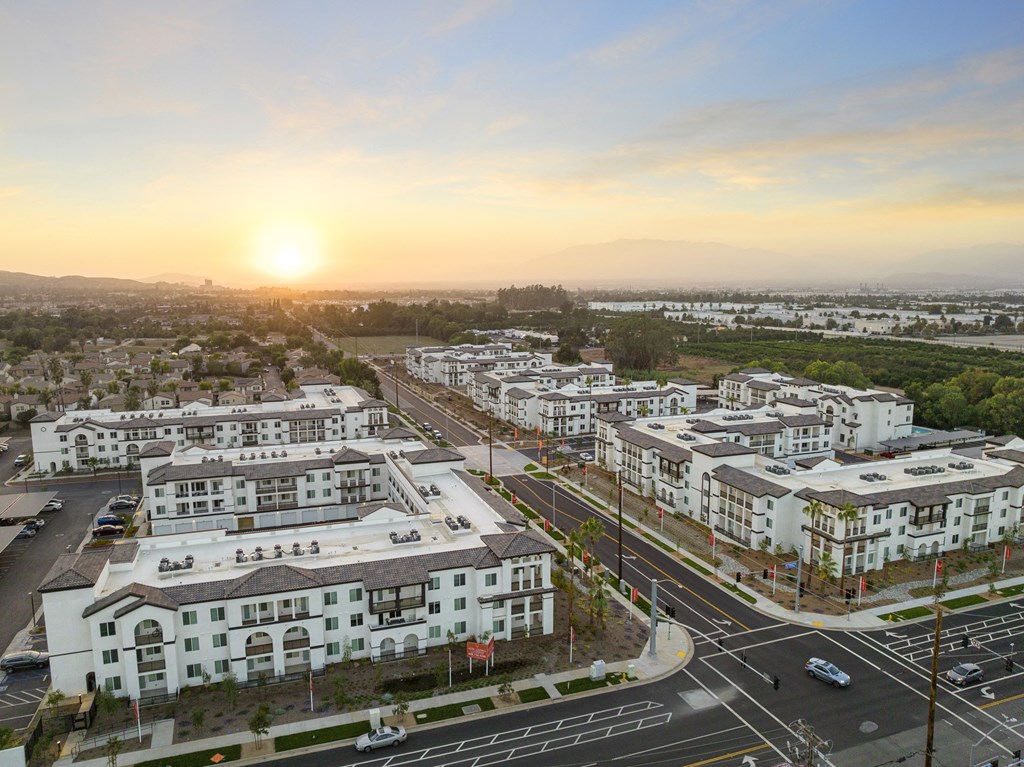 an aerial view of an urban city at sunset at The Venue at Orange Apartments, Redlands, CA