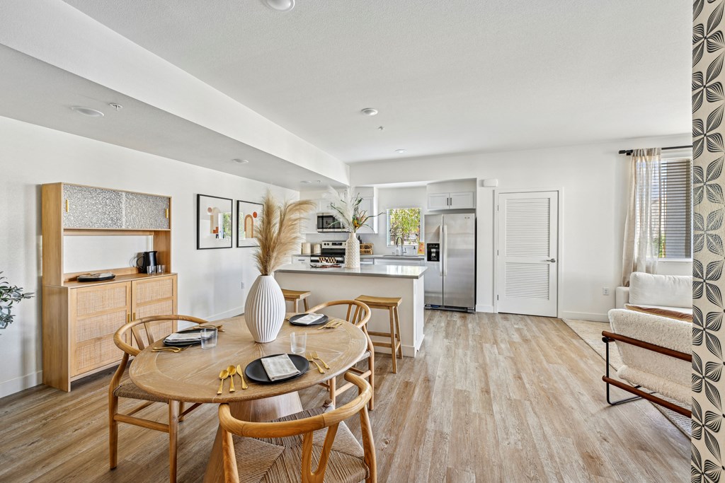 a living room and dining room with a table and chairs at The Venue at Orange Apartments, Redlands