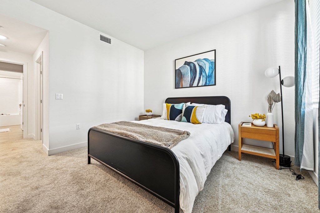 a bedroom with a bed and a large window at The Venue at Orange Apartments, Redlands, 92373