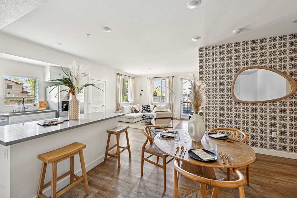 a living room with a kitchen and a dining table at The Venue at Orange Apartments, California, 92373