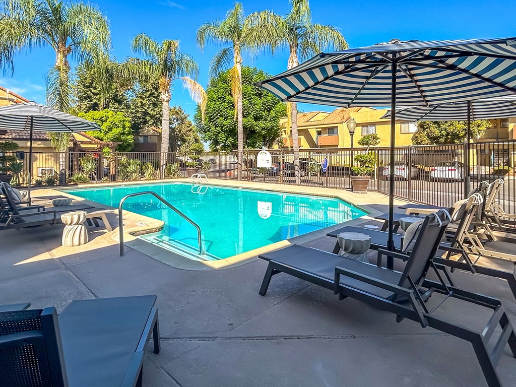 swimming pool with chair lounge and umbrella