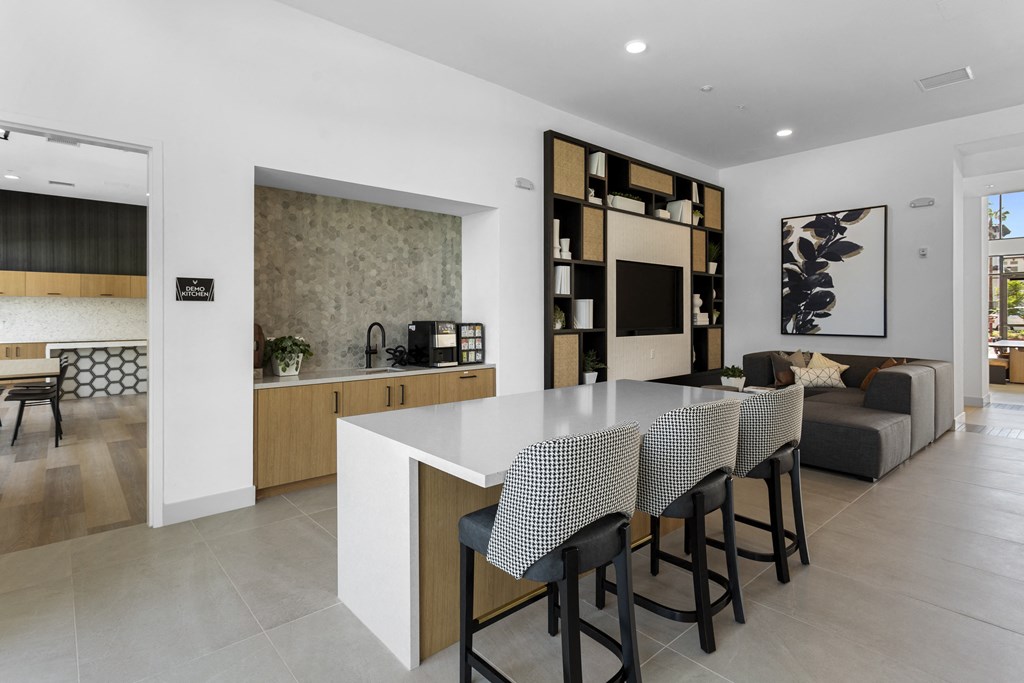 a kitchen and living room with a table and chairs at The Venue at Orange Apartments, Redlands, CA, 92373