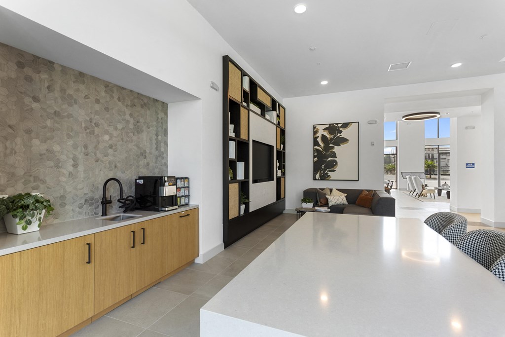 a kitchen and living room with a white counter top at The Venue at Orange Apartments, Redlands, CA, 92373