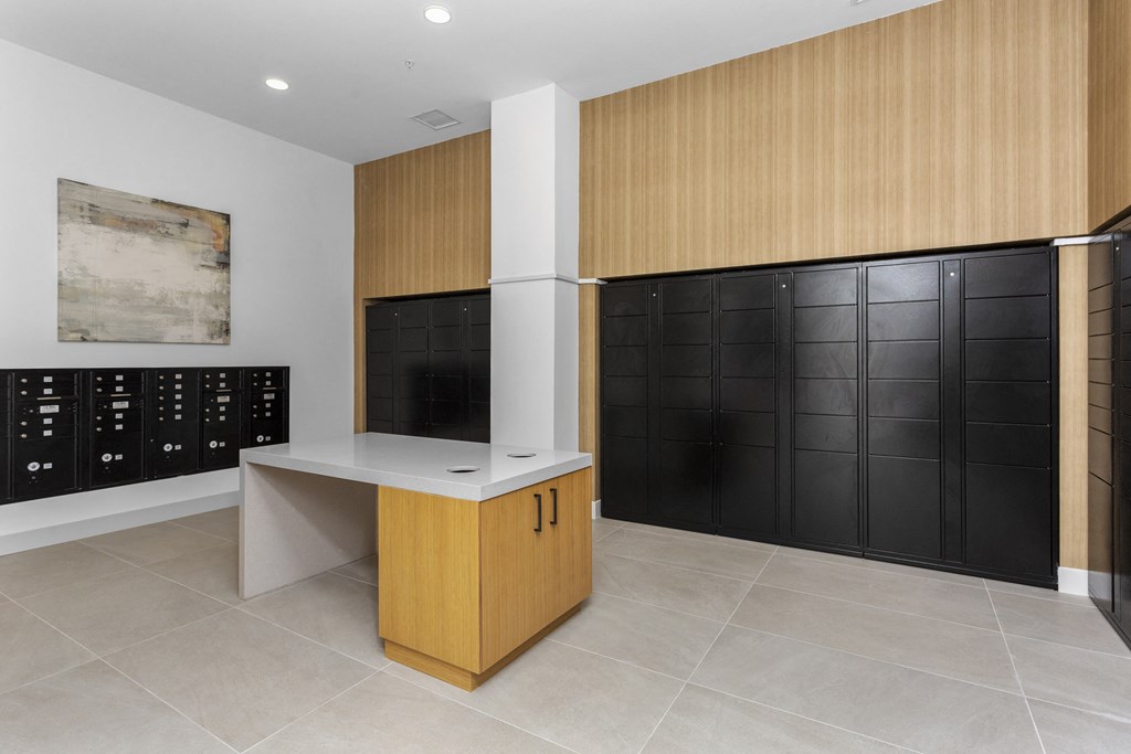 a wine room with black lockers and a counter and a wall of cabinets at The Venue at Orange Apartments, Redlands, CA, 92373