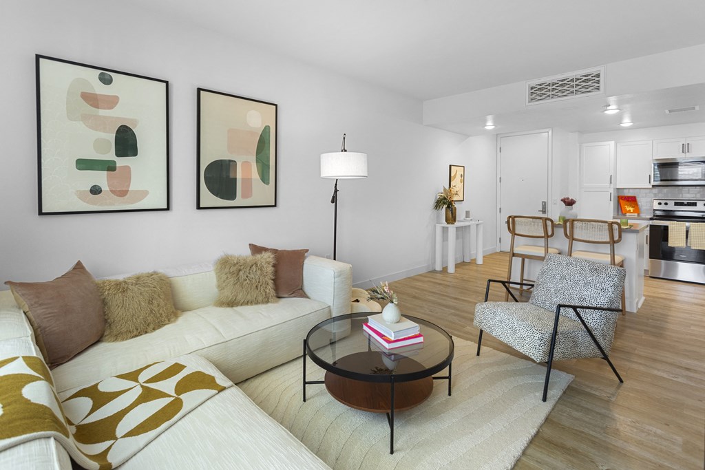 a living room with a couch and a coffee table at The Venue at Orange Apartments, Redlands, 92373