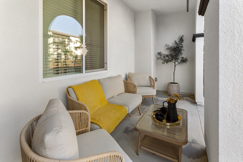 a living room with couches and chairs and a table at The Venue at Orange Apartments, California