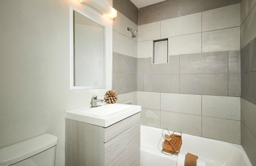 a white bathroom with a sink and a bath tub