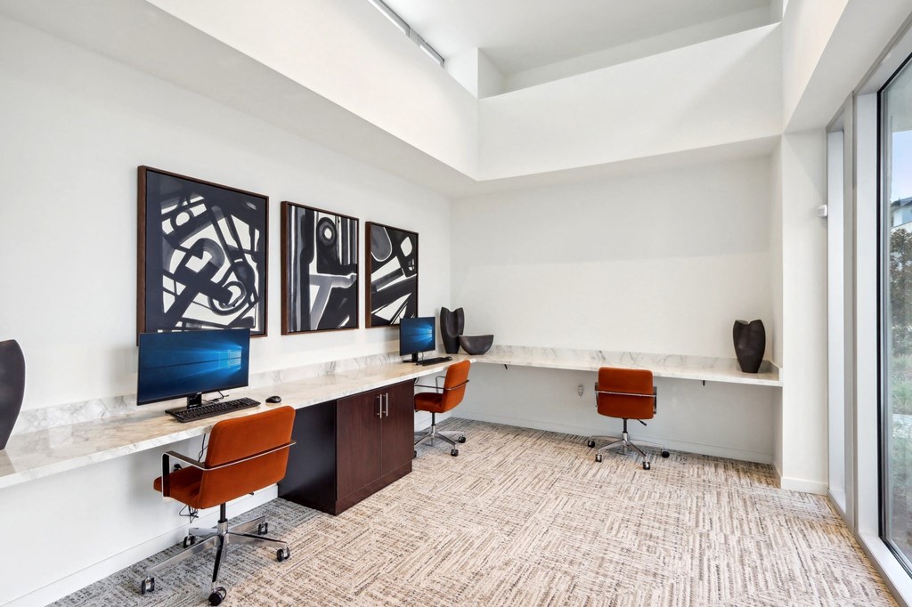 a large office with desks and chairs and a window at The Max on Jefferson Apartments, Murrieta, 92562