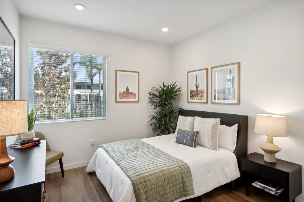 a bedroom with a bed and a window at The Max on Jefferson Apartments, Murrieta, CA, 92562