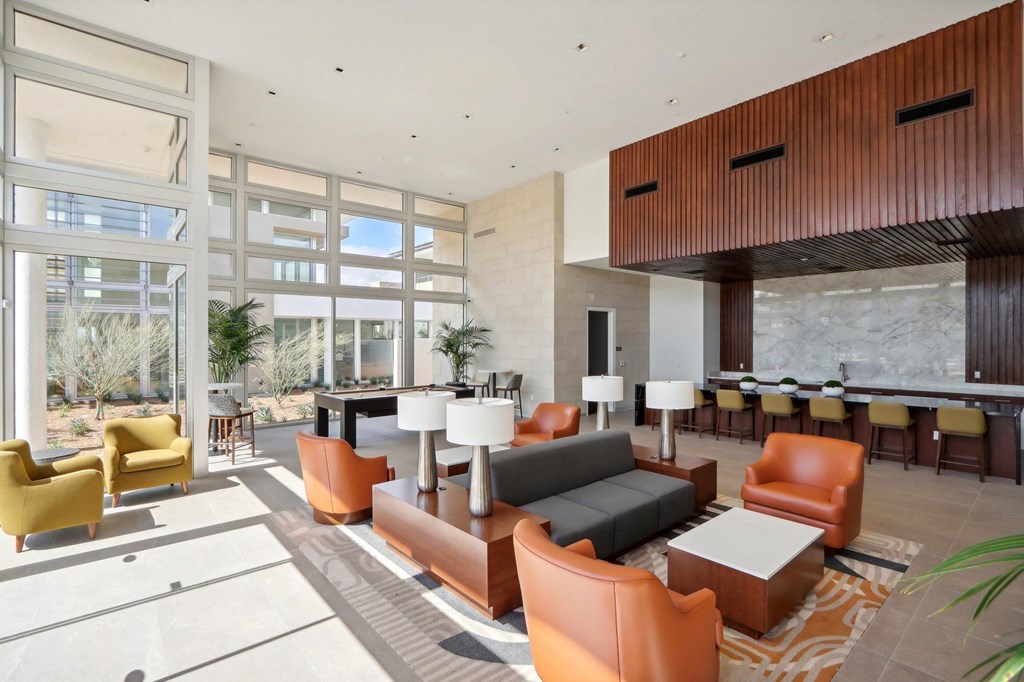 a rendering of a large lobby with couches and chairs at The Max on Jefferson Apartments, Murrieta, CA, 92562