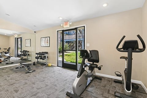 Fitness center at Oro Apartments with plenty of machines and bright lighting