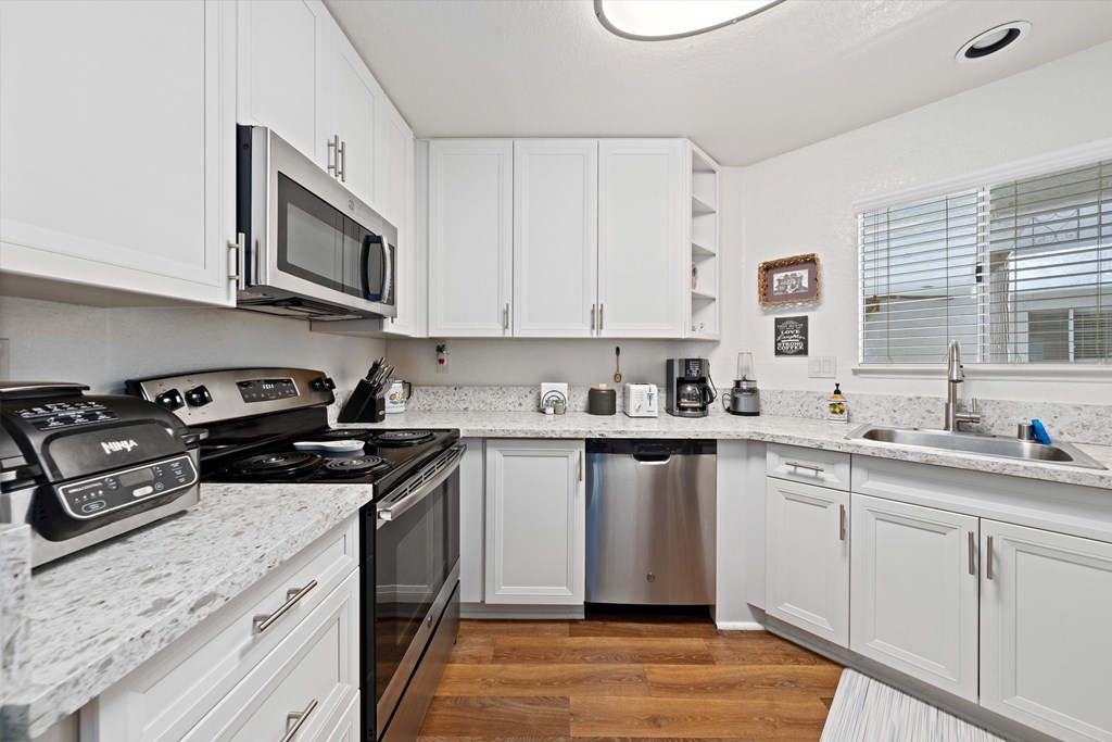 kitchen photo with stainless steel appliances with white color cabinets