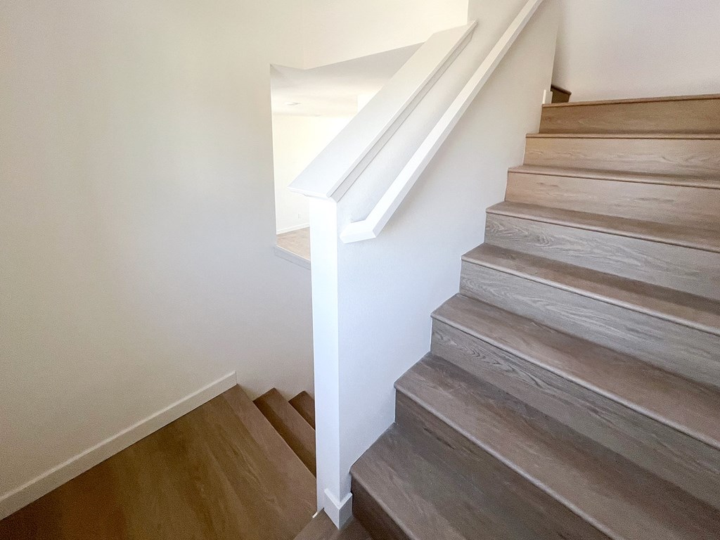 an image of a staircase in a home with wood flooring at The Willow Townhomes, Ontario