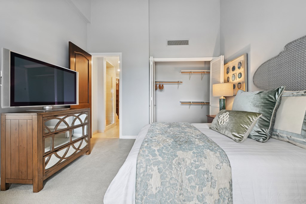 a bedroom with a large bed and a tv