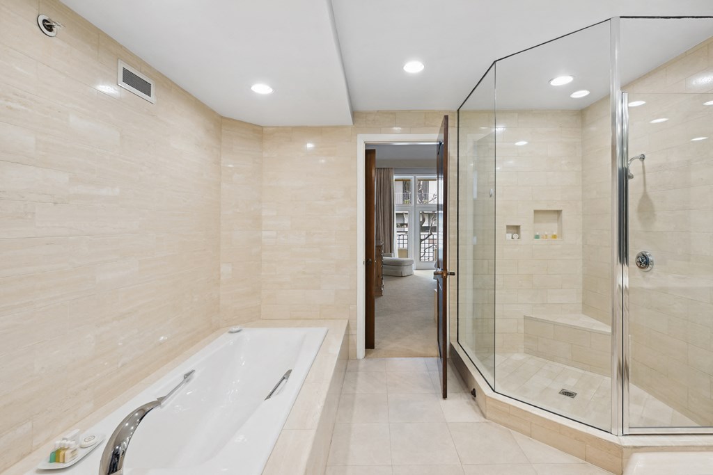a large bathroom with a tub and a shower