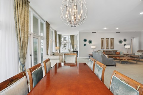 a dining room with a long wooden table and chairs