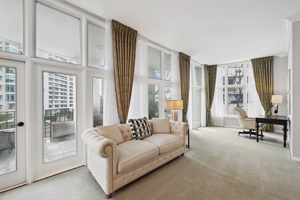 a living room with a couch and large windows