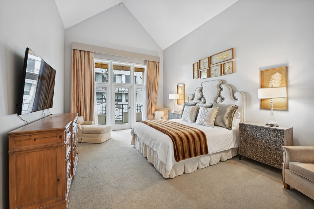 a bedroom with a bed and a dresser and a tv