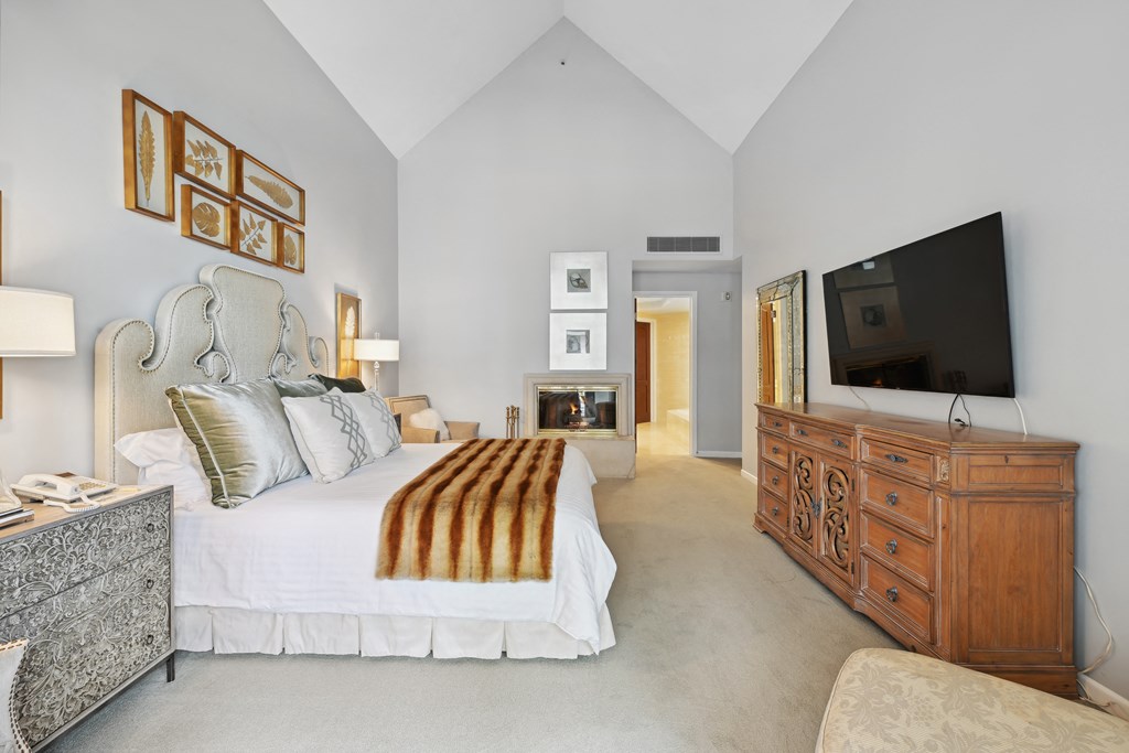 a bedroom with a bed and a dresser and a tv