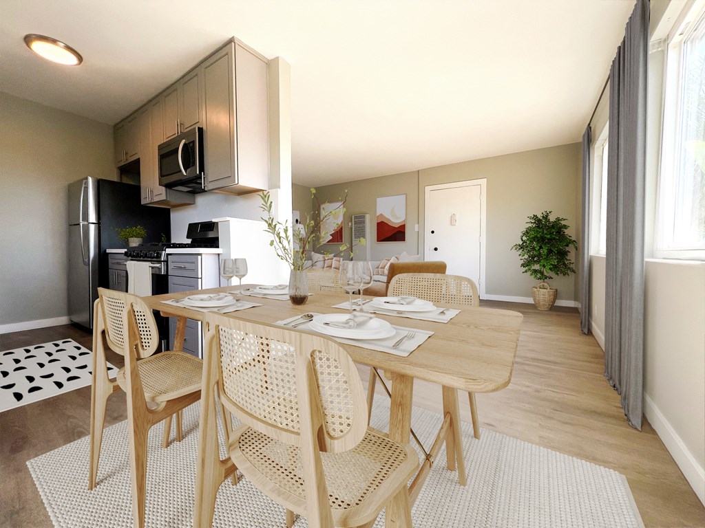 a dining room with a wooden table and chairs