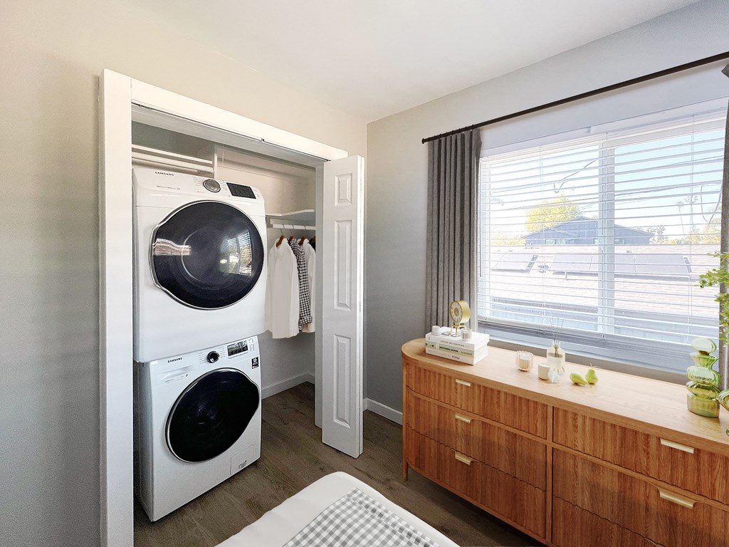a bathroom with a washing machine and a dryer in it