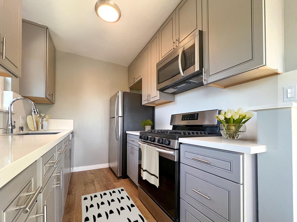 a kitchen with stainless steel appliances and white cabinets