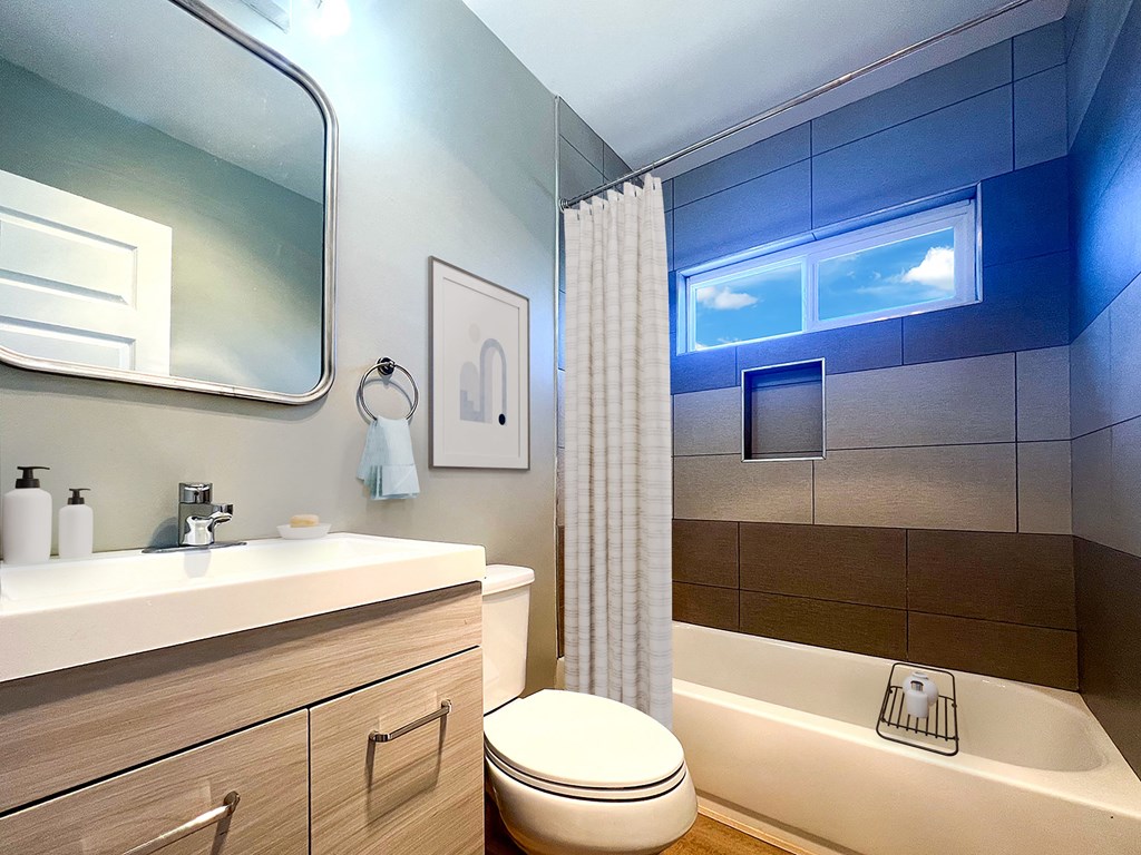 a bathroom with a toilet and a sink and a shower