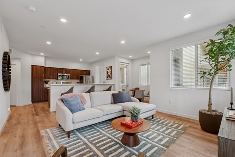 A living room with a white couch and a coffee table.