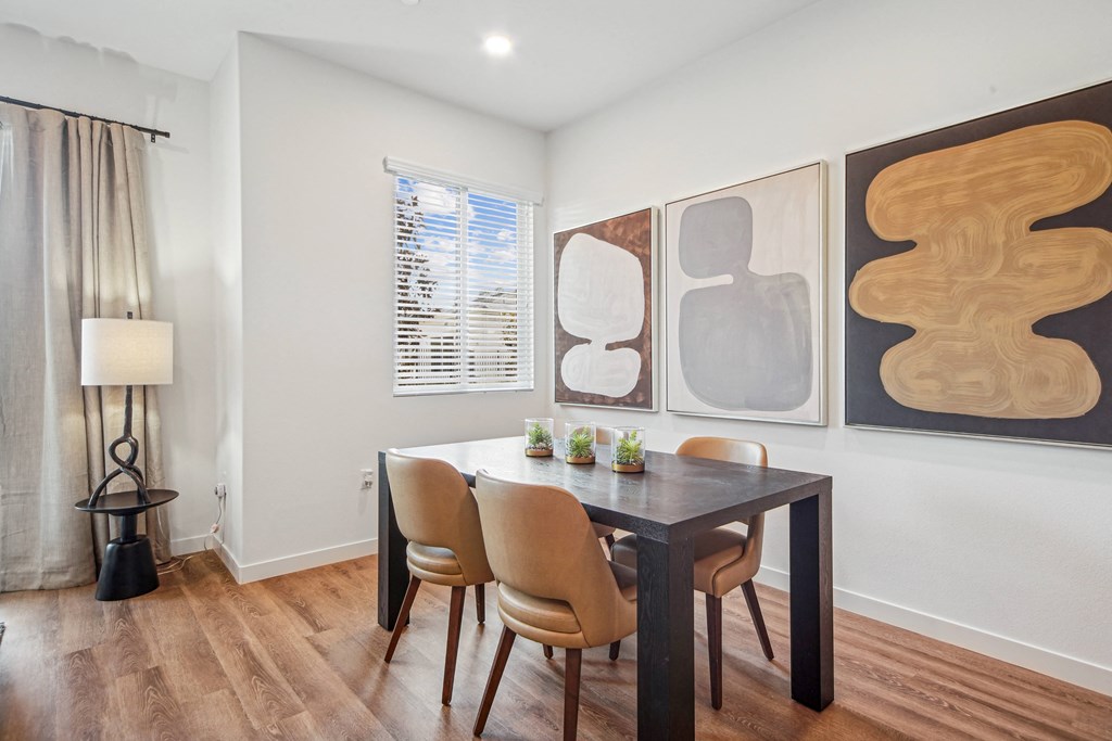 A dining room with a table and chairs at The Max on Jefferson Apartments, Murrieta, CA