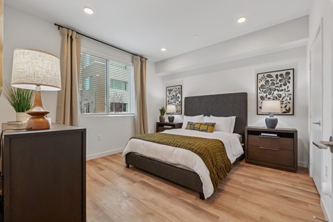 Bedroom with upholstered bed and wood flooring at The Park on Washington Apartments, Murrieta, CA 92562