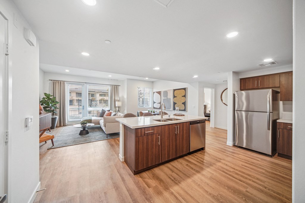 A modern kitchen with wooden floors and stainless steel appliances. at The Max on Jefferson Apartments, Murrieta, CA, 92562