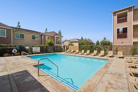 Resort-style pool area at Turtle Creek surrounded by chaise lounges for optimal relaxation.