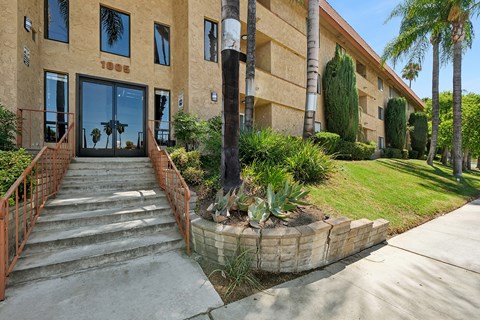 A building with a brown facade and a red railing.