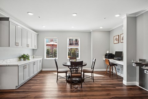 Dining area in Turtle Creek community clubhouse with seating, plus computer desk for business center, and kitchenette.