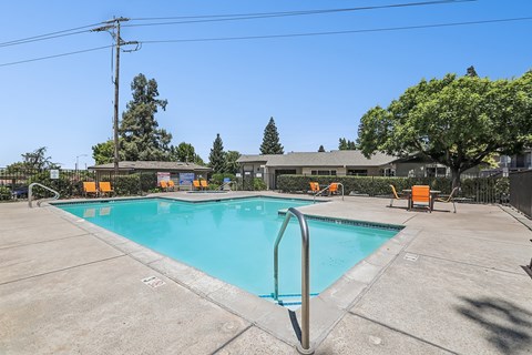 Luxurious swimming pool at Bent Tree surrounded by chaise lounges and dining tables for the ultimate poolside experience.