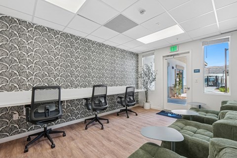 Coworking space with desk stations and lounge seating at Altitude Apartments, Moreno Valley, CA
