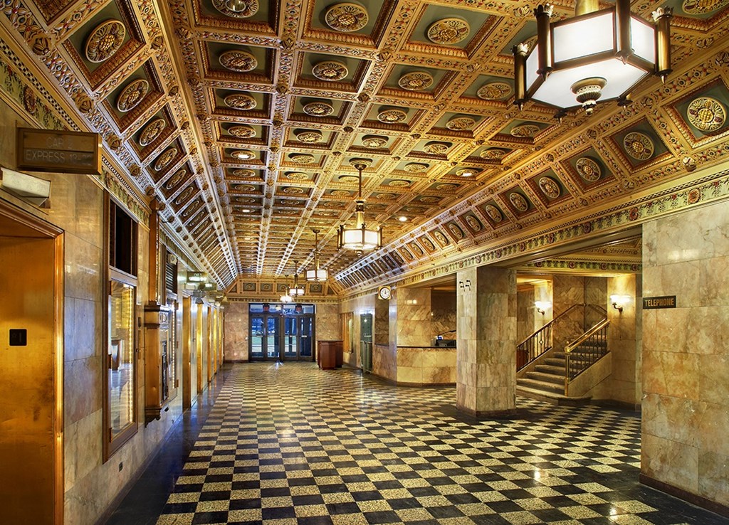 a view of a hallway with a checkered floor and a coffered ceiling