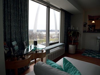 a living room filled with furniture and a large window overlooking the Gateway Arch monument - Photo Gallery 8