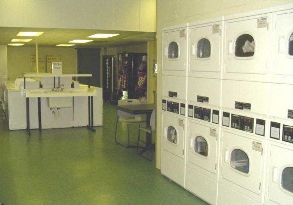 onsite 24-hour laundry room filled with lots of white washers and dryers